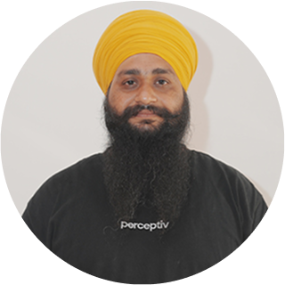 Manager Singh, Head of Development at Perceptiv Media, wearing a yellow turban and black shirt, with the company logo visible, representing the Indian team dedicated to innovative marketing solutions.