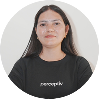 Ruchi Sharma, Full Stack Developer at Perceptiv Media, wearing a branded black t-shirt, smiling against a neutral background.