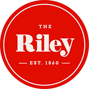 Riley logo in red circle, representing a historic brand established in 1860, emphasizing heritage and identity.