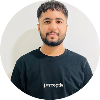 Ravinder Raj, WordPress Developer at Perceptiv Media, wearing a black t-shirt with the brand logo, smiling against a neutral background.