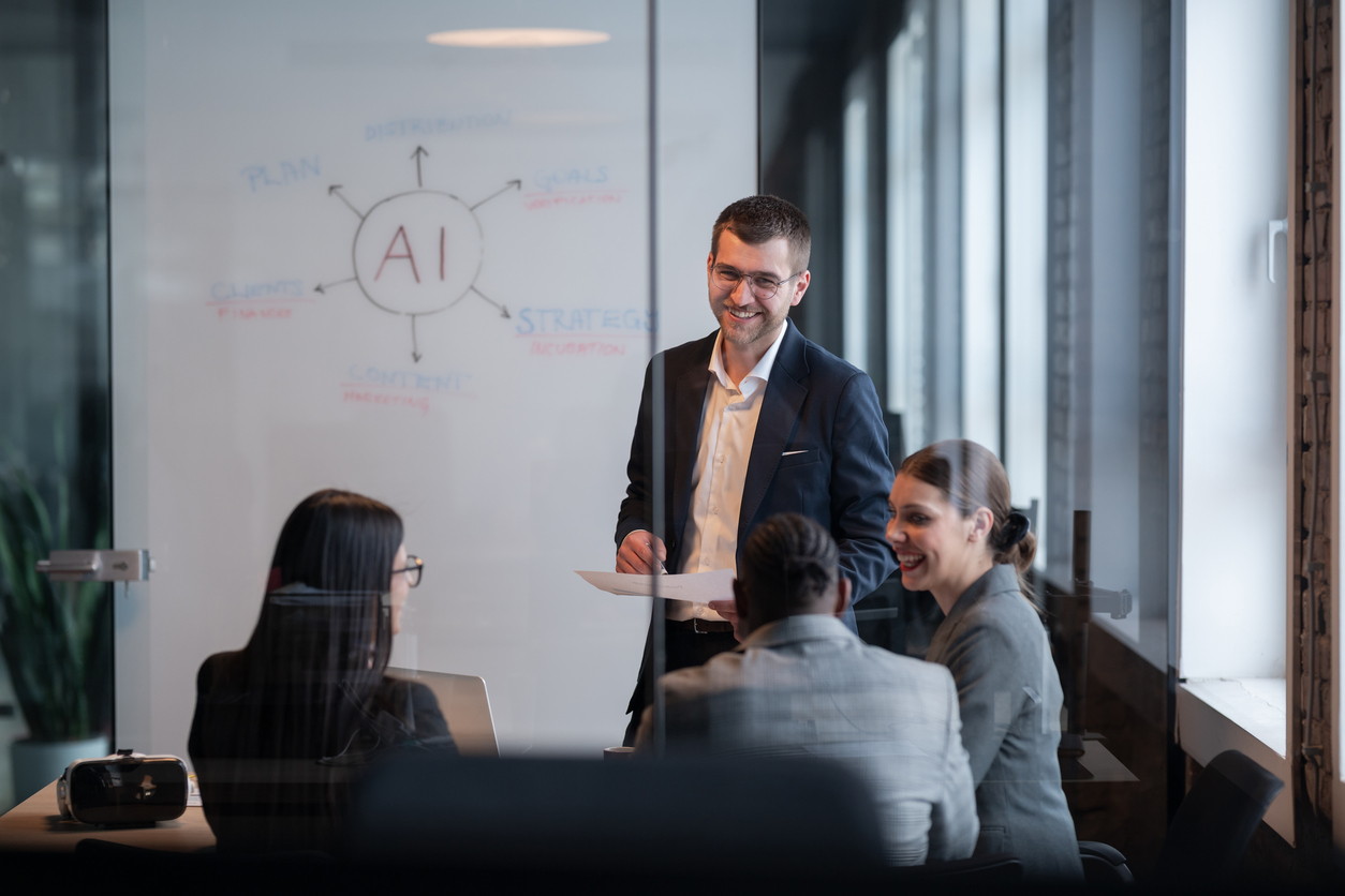 Business meeting discussing AI strategies for SEO, with a presenter and engaged audience, whiteboard illustrating AI concepts in digital marketing.