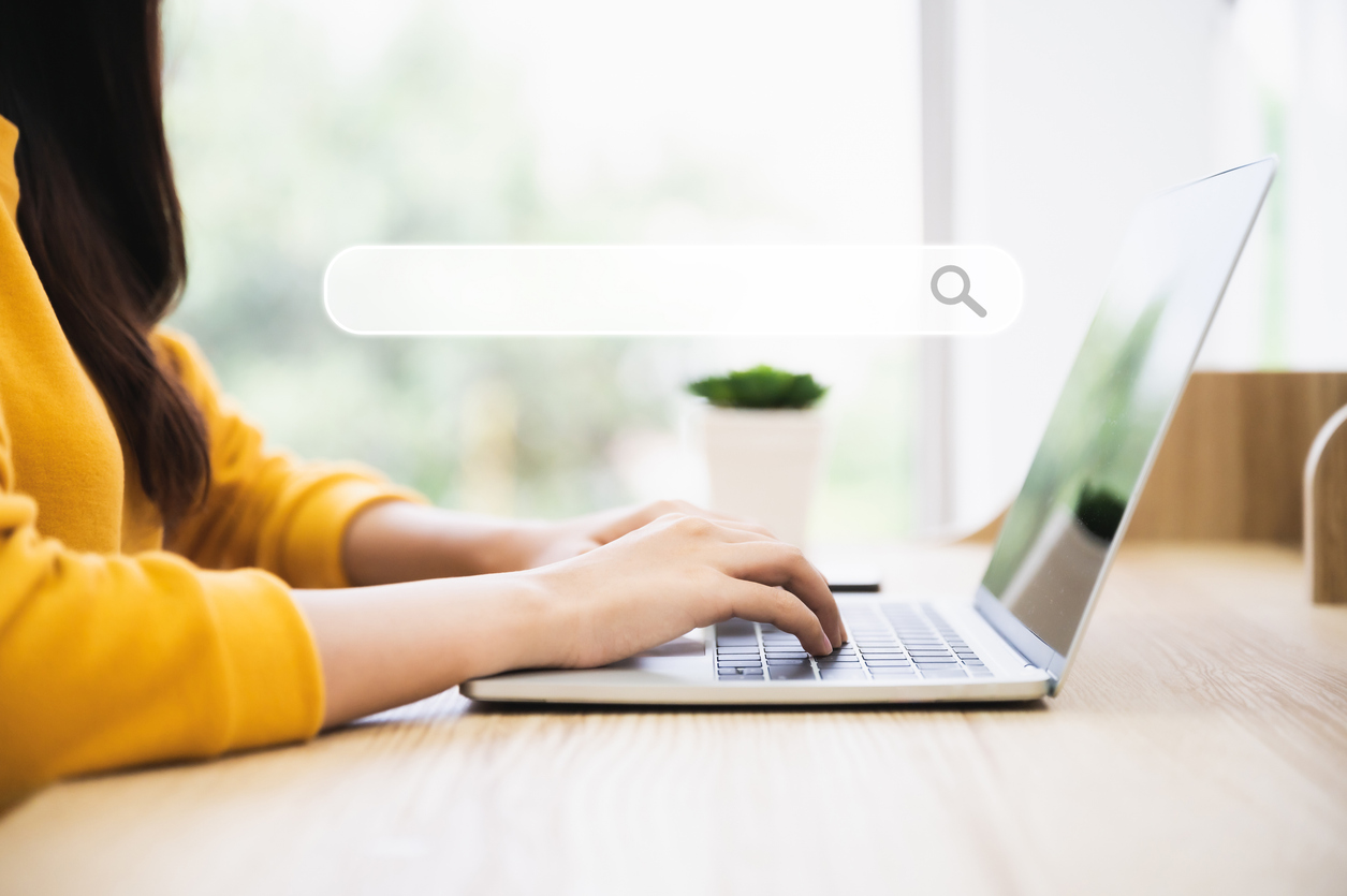Person typing on laptop with search bar, emphasizing local SEO strategies and digital marketing for Sydney businesses.